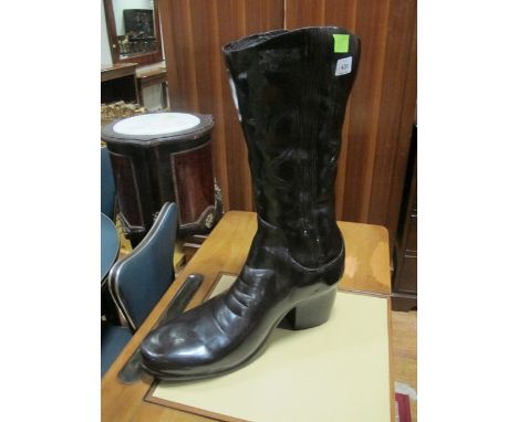 A BRONZE STICK STAND in the form of a cowboy boot 61cm high