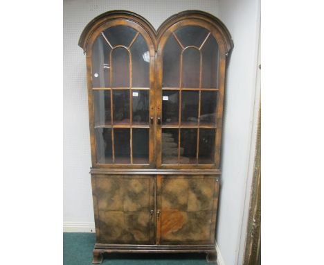 A GEORGIAN STYLE WALNUT DOUBLE DOME TOP DISPLAY CABINET the shaped moulded top above astragal glazed doors the base with pane
