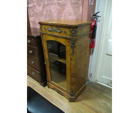 A BURR WALNUT AND GILT BRASS MOUNTED SIDE CABINET the rectangular top with eared corners above a frieze drawer and arched gla