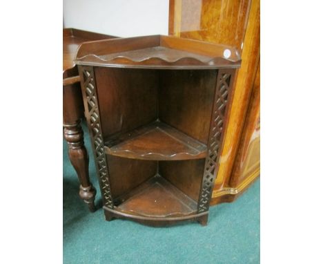 A MAHOGANY CORNER SHELF 19th Century with moulded gallery above two open shelves between pierced uprights on bracket feet 84c