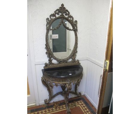 A CONTINENTAL GILTWOOD CONSOLE TABLE AND MIRROR the oval plate within a flowerhead and foliate moulded frame hung with floral