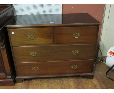 A GEORGIAN STYLE MAHOGANY CHEST the rectangular top above two short drawers and two long drawers with brass drop handles on b