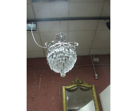 A CONTINENTAL CHROME AND CUT GLASS FOUR LIGHT CHANDELIER hung with cascading pendants 77cm drop
