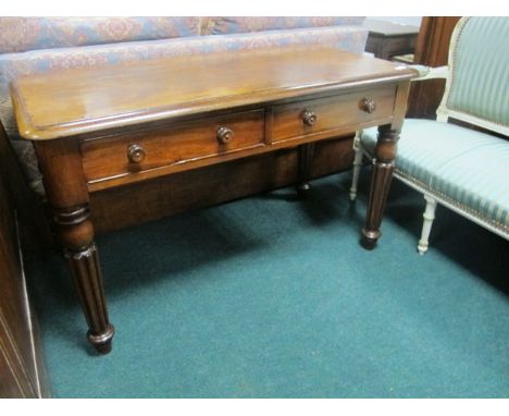 A WILLIAM IV MAHOGANY LIBRARY TABLE the shaped moulded top above two frieze drawers on lobed and ring turned legs stamped "R 