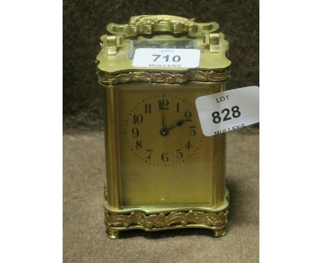 A FRENCH BRASS CARRIAGE CLOCK the engraved case with foliate scrolled handle on turned legs