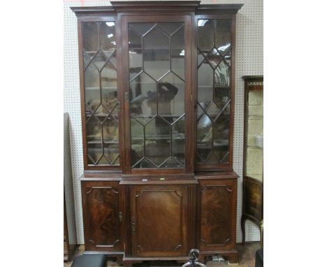 A GOOD GEORGIAN MAHOGANY LIBRARY BOOKCASE of breakfront outline the outset moulded cornice above astragal glazed doors with a