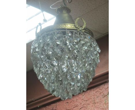 A CONTINENTAL GILT BRASS AND CUT GLASS BASKET SHAPED CENTRE LIGHT hung with faceted pendants 