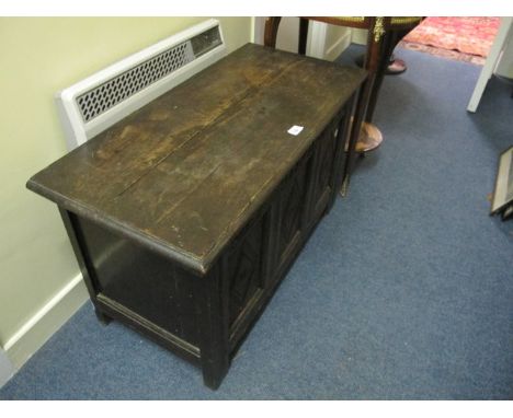 A CARVED OAK TRUNK 19th Century the rectangular hinged top above a carved frieze on square block legs 55cm (h) x 93cm (w) x 4