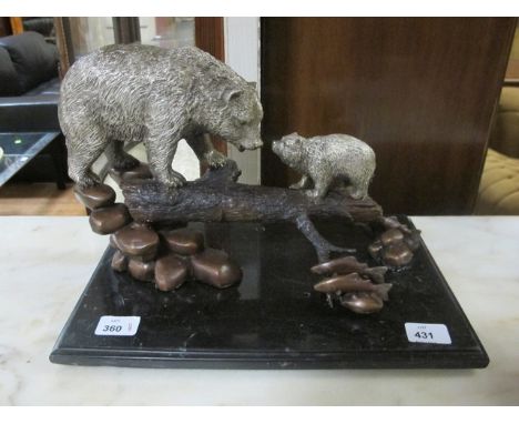 A BRONZE AND SILVERED FIGURE modelled as a bear and cub shown standing on a tree trunk raised on a black marble base 26cm x 3