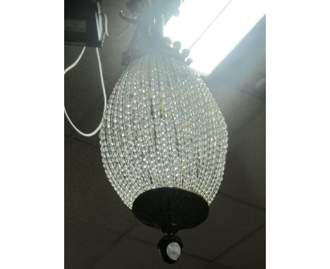 A CONTINENTAL GILT BRASS AND CUT GLASS CENTRE LIGHT of bulbous form with cut glass cascading beads surmounted with a reeded c