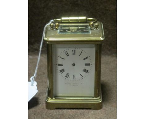 A BRASS CARRIAGE CLOCK with enamel dial