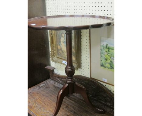 A MAHOGANY OCCASIONAL TABLE the circular pie crust top above a baluster column on tripod support 80cm (h) x 55cm (w)