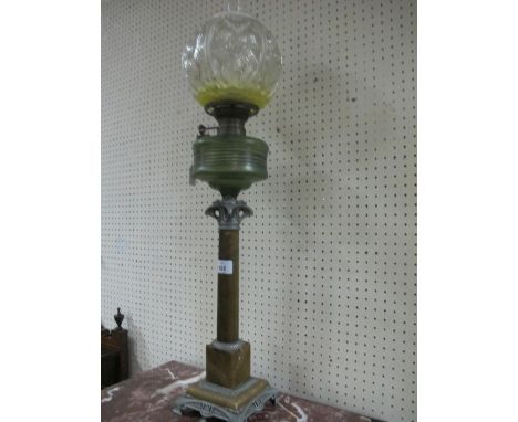 AN ART DECO ALABASTER AND WHITE METAL OIL LAMP with moulded glass shade above green glass resevoir raised on cylindrical colu