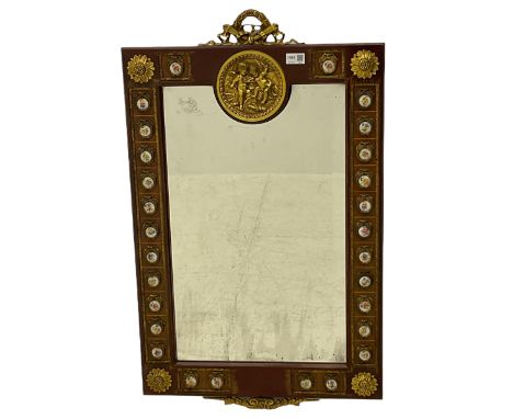 French walnut framed classical wall mirror, circular brass cherub panel, Limoges type porcelain roundels, bevelled plateDimen