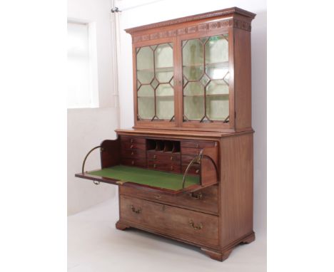 A George III mahogany glazed secretaire-bookcase - the flared, dentil cornice over a fluted and foliate paterae-decorated fri