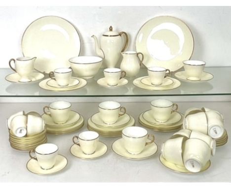 An early 20th century Wedgwood tea and coffee service - plain ivory glaze with gilt lined rims and handles, brown printed fac
