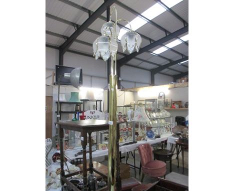 A brass standard lamp with 3 lights