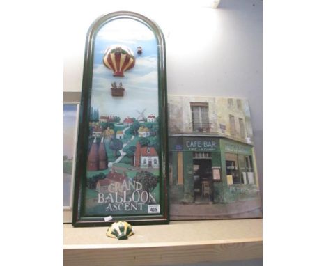 A pub style sign and a canvas print of a café bar