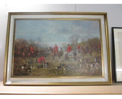 A large framed hunting print showing riders and hounds