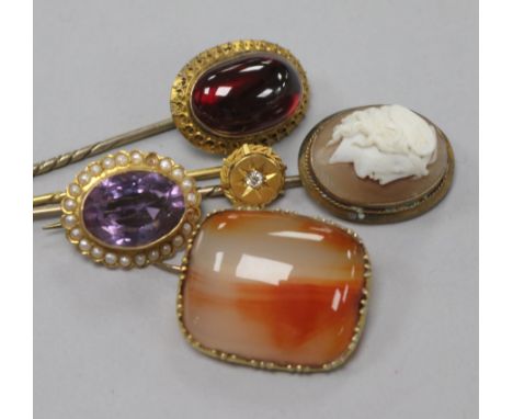 Three stick pins including one Edwardian 15ct gold and diamond and two brooches including one 9ct gold and amethyst.