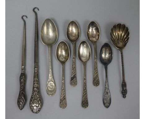 Two silver handled button hooks, a sterling silver teaspoon, a silver preserve spoon and five plated spoons.