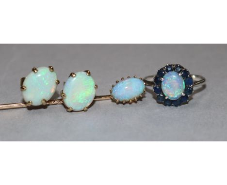 A white metal, white opal and sapphire cluster ring, a pair of yellow metal and white opal earrings and a white opal stick pi