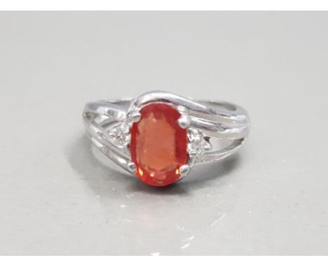 18CT WHITE GOLD FIRE OPAL STONE AND DIAMOND RING FEATURING AN OVAL ORANGE STONE SET IN THE CENTRE WITH A DIAMOND EITHER SIDE 