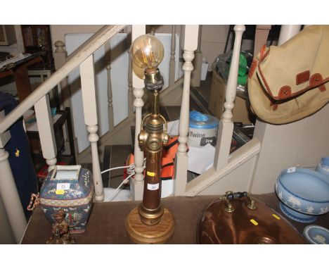 A copper and brass lamp formed from a fire hose nozzle, stamped Bendix