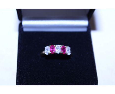 A silver gilt, cubic zirconia and ruby coloured stone set ring 