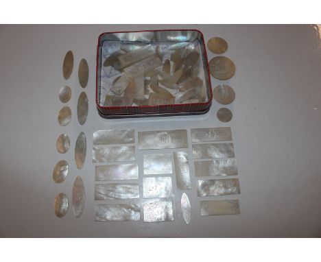 A tin containing Chinese engraved mother of pearl gaming counters