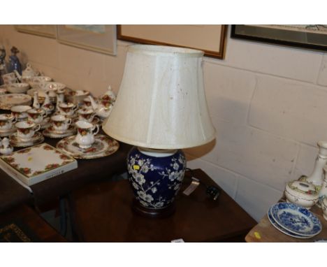A blue cherry blossom decorated table lamp and shade