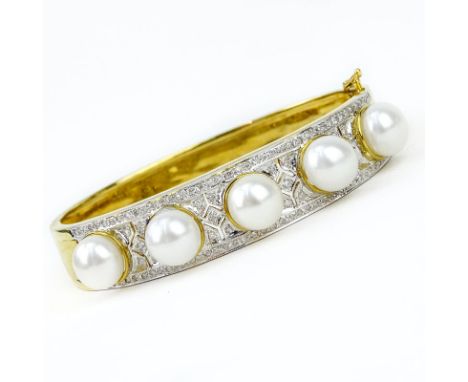 Finely Made Pave Set Diamond, South Sea Pearl and 18 Karat Yellow Gold Hinged Bangle Bracelet. Pearls measure 9mm. Stamped 18