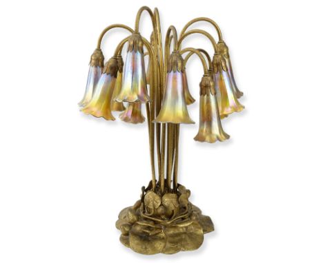 Important Tiffany Studios Twelve-Light Pond Lily Lamp. The pond lily base of dore bronze, the drop cluster blossom design sha