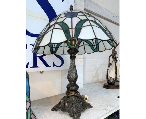 A late 20th century Tiffany style bronzed table lamp with leaded glass shade 