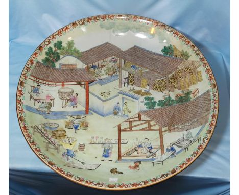 A large impressive Chinese charger decorated extensively with a Chinese ceramic workshop scene in the 18th century manner, fl