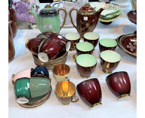 A Carltonware Rouge Royale set of 12 teacups and saucers; a set of 6 cabaret cups and saucers; 2 coffee pots 
