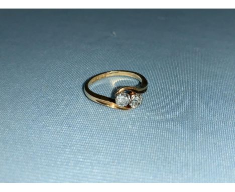 An early 20th century 18 carat gold ring with 2 diamonds in crossover setting, diamond weight 0.55 ct, weight 3 gm, size M 