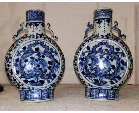 A pair of Chinese porcelain moon flasks decorated with dragons in underglaze blue, 20 cm (one neck a.f.)