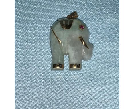 A carved jade elephant pendant set with ruby eye, mounted in yellow metal, stamped '14K' 