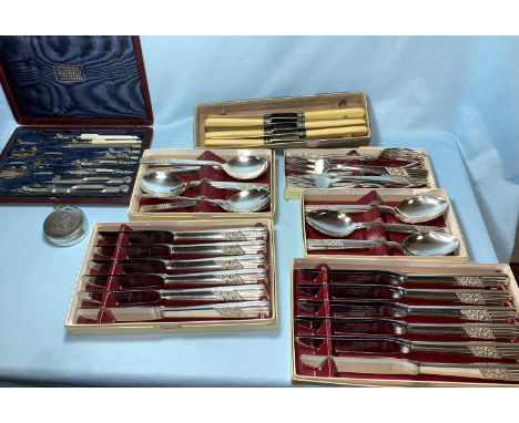 A silver plated 2 bottle tantalus; a geometry set; various cutlery 