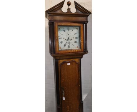 An early 19th century oak longcase clock, the later case with mahogany crossbanding, the hood with broken arch pediment and r