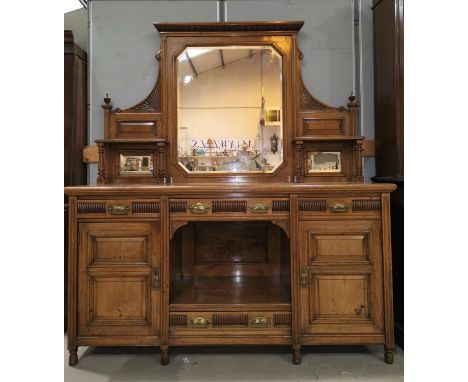 An Edwardian figured golden oak sideboard with central rectangular mirror back, 4 drawers, 2 cupboards and open shelf to base