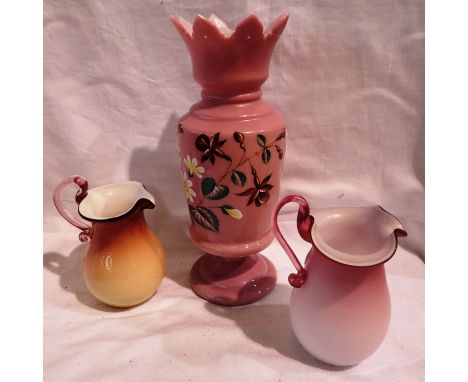 Victorian pink opaline glass crown vase, H: 26 cm. and two jugs, small manufacturers error to yellow jug, small chip to back 