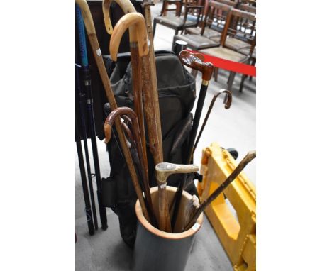 A tall ceramic crock containing a selection of 11 sticks