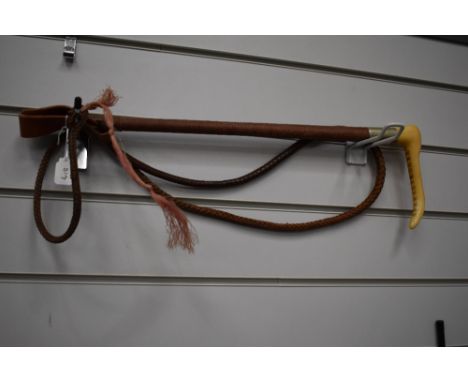 A vintage hunting whip marked swaine