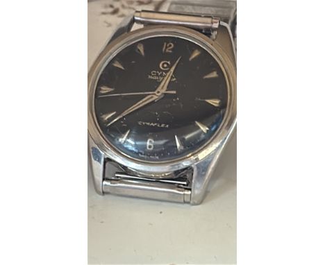 Vintage Cyma NavyStar Cymaplex wristwatch with black dial, silver indices, and luminous hands. Stainless steel case with expa