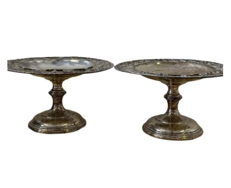 Pair of silver taza's with pierced floral decoration, each has embossed coat of arms. Birmingham hallmark date letter Q, Make
