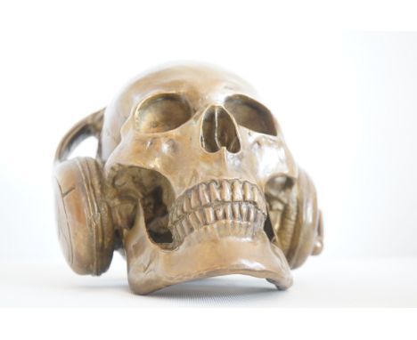 Bronze skull wearing headphones 