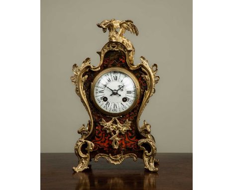 A late 19th century French Boulle decorated mantle clock, the shaped case with ormolu mounts in the form of rocaille scrolls 