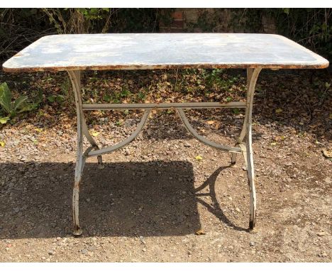 A zinc topped white painted iron garden table on curving trestle base, 120cm wide x 70cm deep x 75cm highWhite paint very dam